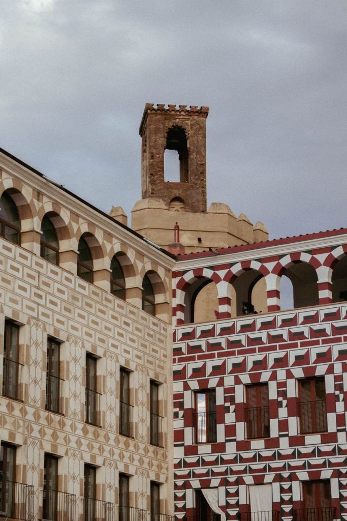 clouds over ancient tower and ornamented building